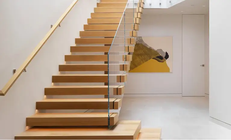 Modern floating staircase with wooden steps and glass railings, featuring LED lighting and a minimalist design.